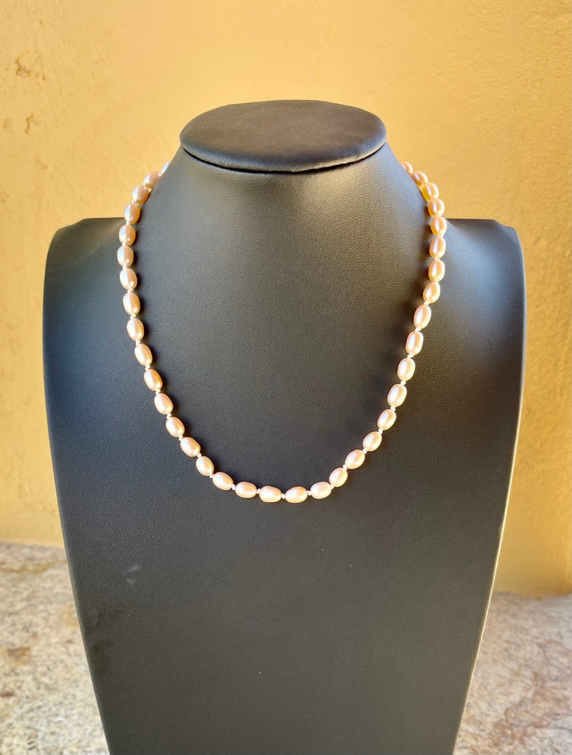 Necklace - knotted coral rice pearls with a sterling silver clap