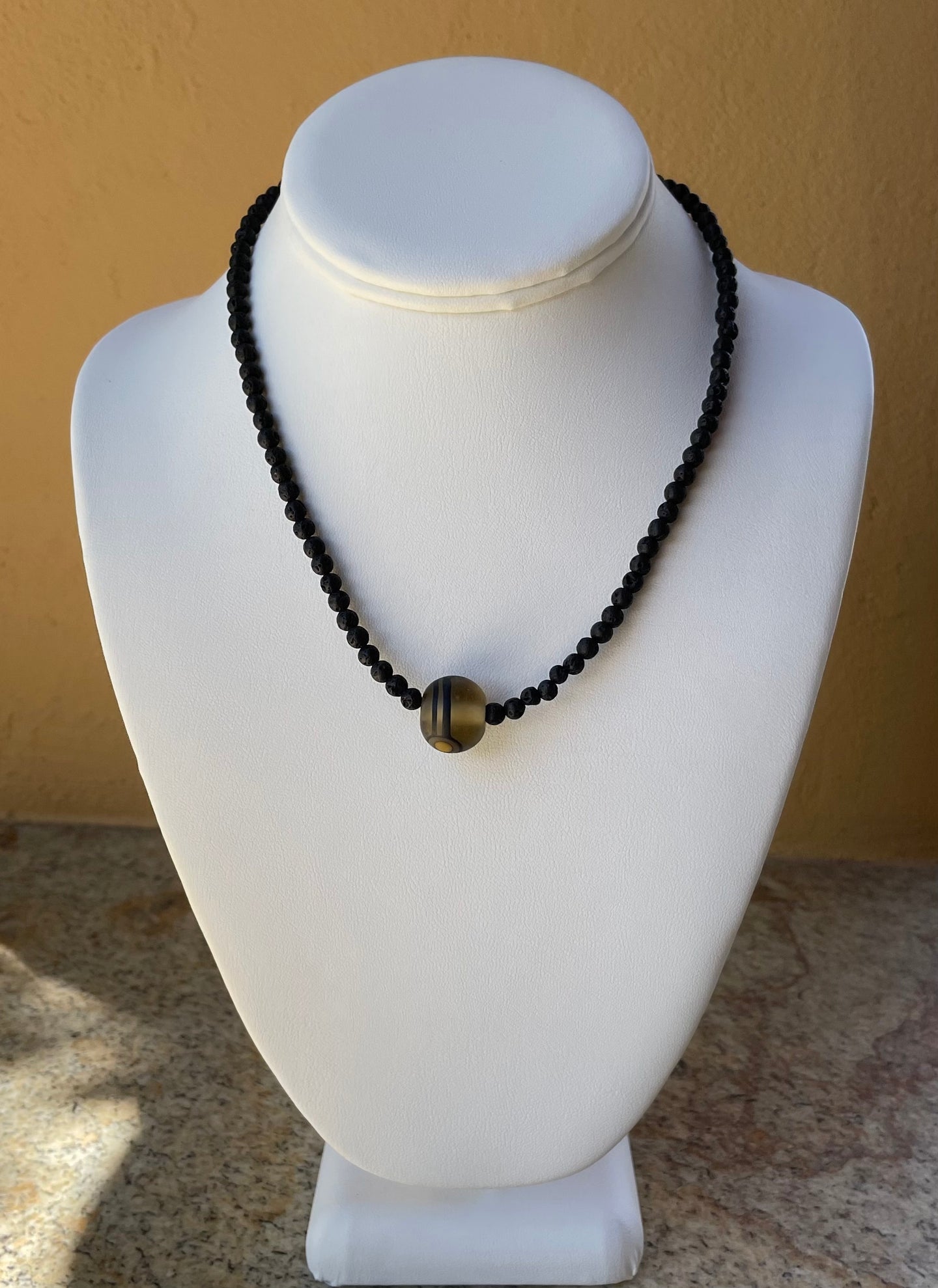 Necklace - Black lava stone round beads with a hand made glass focal point