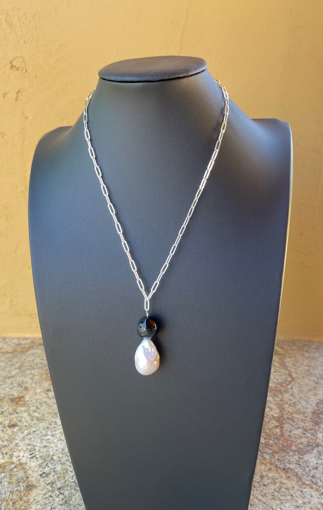 Necklace - Sterling silver chain with a white pearl and black onyx pendant